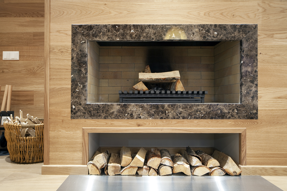 modern fireplace with a stack of wood